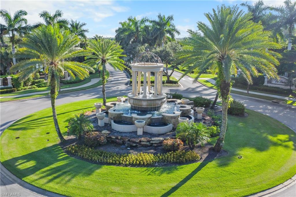 9727 Acqua Court, Unit 436 Naples, FL 34113 - Photo 21 of 40 a view of a swimming pool with a garden