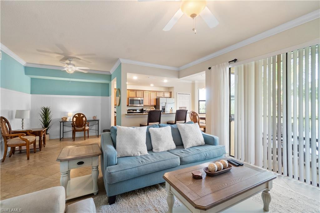 9727 Acqua Court, Unit 436 Naples, FL 34113 - Photo 5 of 40 a living room with furniture and a large window