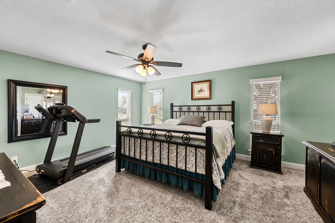 26253 Sharp Road Katy, TX 77493 - Photo 11 of 26 The primary bedroom provides a comfortable, private retreat with direct access to the en-suite bath and walk-in closet, and it also connects seamlessly to the home office for added convenience.