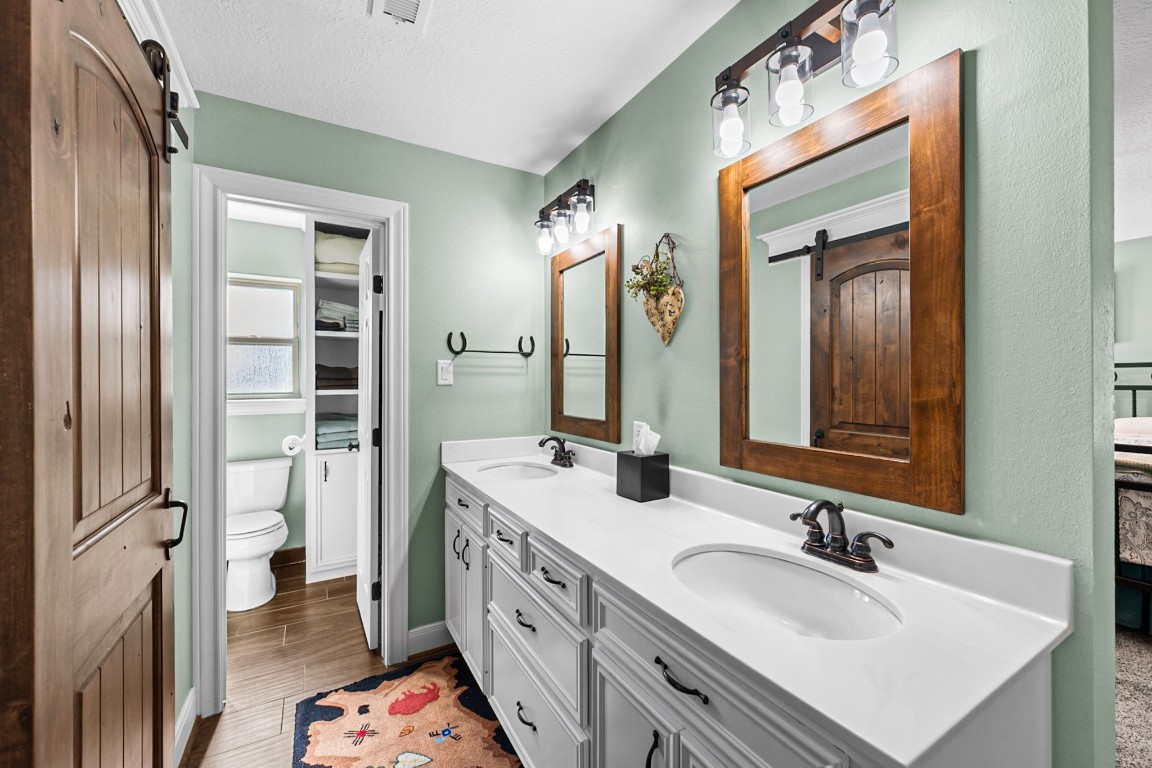 26253 Sharp Road Katy, TX 77493 - Photo 13 of 26 The primary bath offers dual vanities with plenty of storage, roomy enough to move around comfortably.