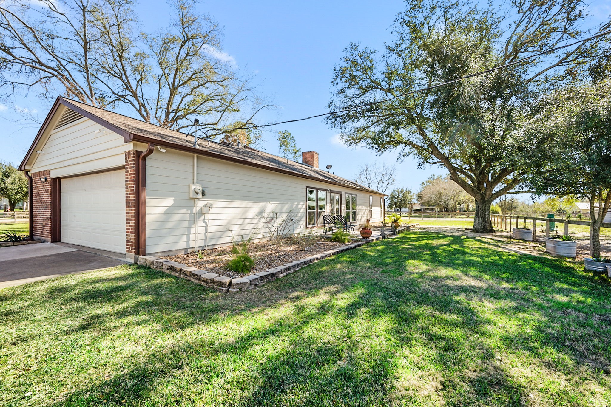 26253 Sharp Road Katy, TX 77493 - Photo 17 of 25 Step out and discover the inviting backyard with sprinkler system, offering a wonderful green space for outdoor activities and relaxation.