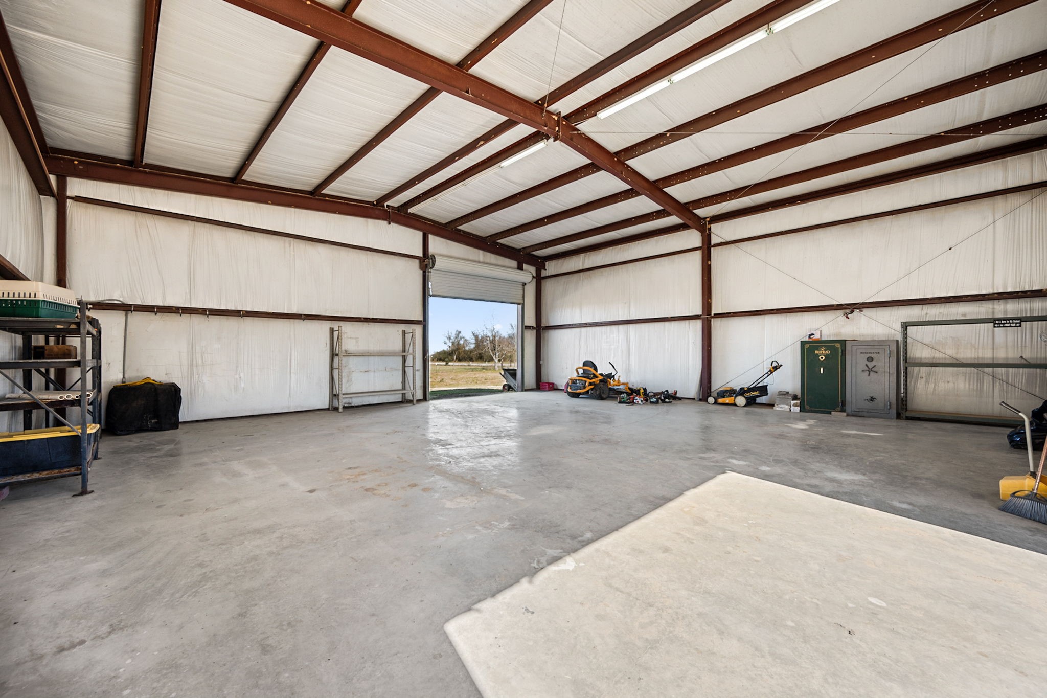 26253 Sharp Road Katy, TX 77493 - Photo 22 of 25 The interior of the barn offers wide-open space with easy access for equipment, storage, or workspace needs.