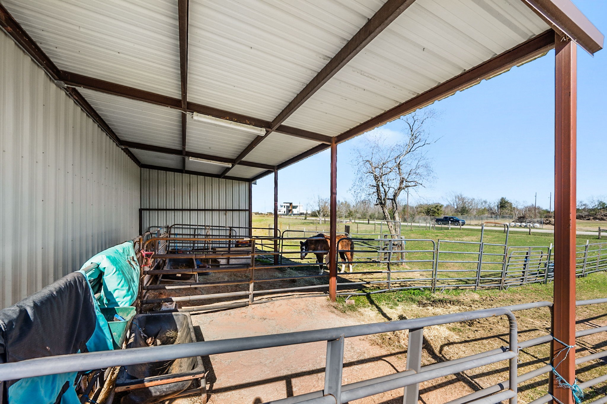 26253 Sharp Road Katy, TX 77493 - Photo 24 of 25 The horse stall offers a well-organized space for daily care, with room for feeding, grooming, and easy access to the surrounding acreage.