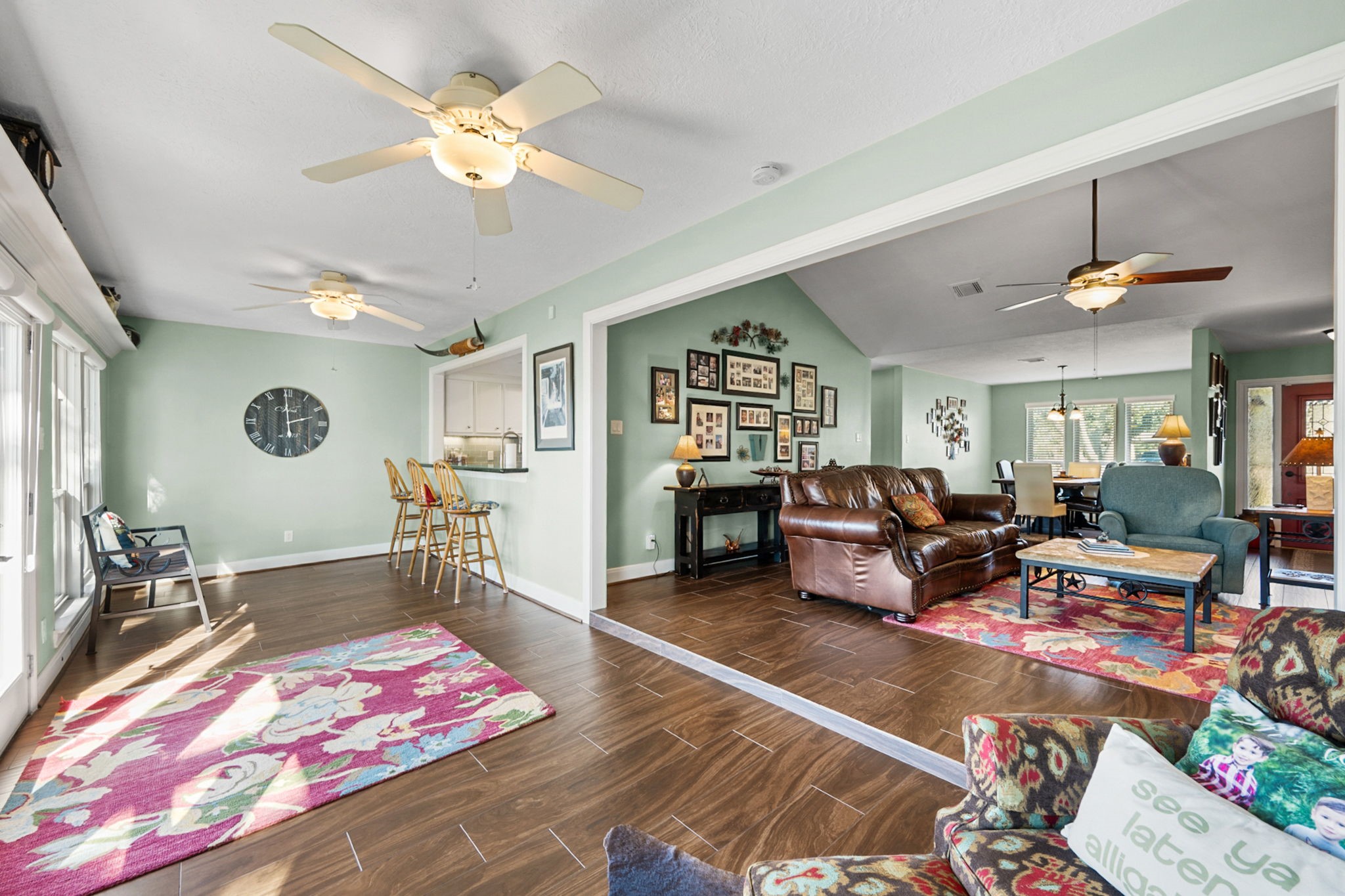 26253 Sharp Road Katy, TX 77493 - Photo 10 of 25 The sitting room offers a spacious layout with two ceiling fans and large windows that bring in plenty of natural light, creating a comfortable spot for everyday use.