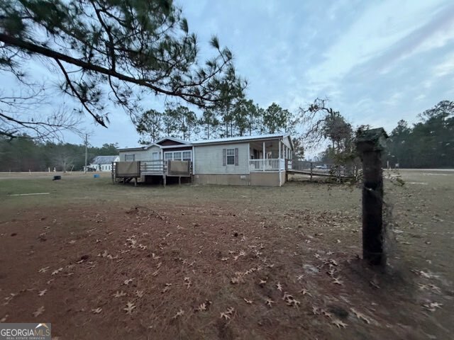 163 Dellwood Road Swainsboro, GA 30401 - Photo 1 of 23 a view of a barn in the middle of a yard