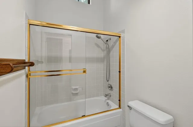 a bedroom with a large bed and a couch