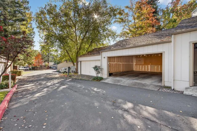 a backyard of a house with fountain table and chairs