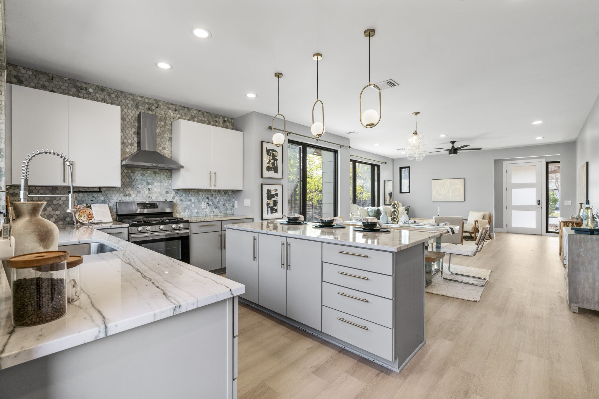 3612 Thompson Street, Unit 1 Austin, TX 78702 - Photo 16 of 40 A chef-forward kitchen anchors the main level with a large island, sleek cabinetry, and statement lighting.
