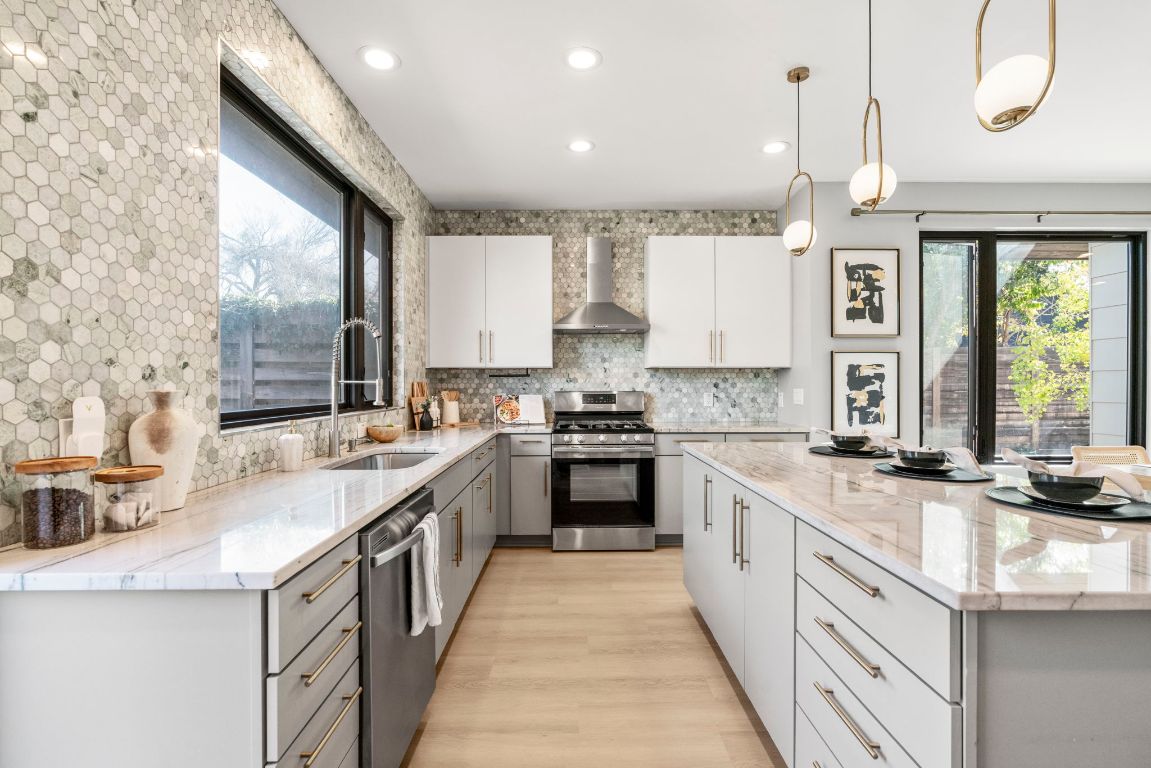 3612 Thompson Street, Unit 1 Austin, TX 78702 - Photo 17 of 40 A chef-forward kitchen anchors the main level with a large island, sleek cabinetry, and statement lighting.