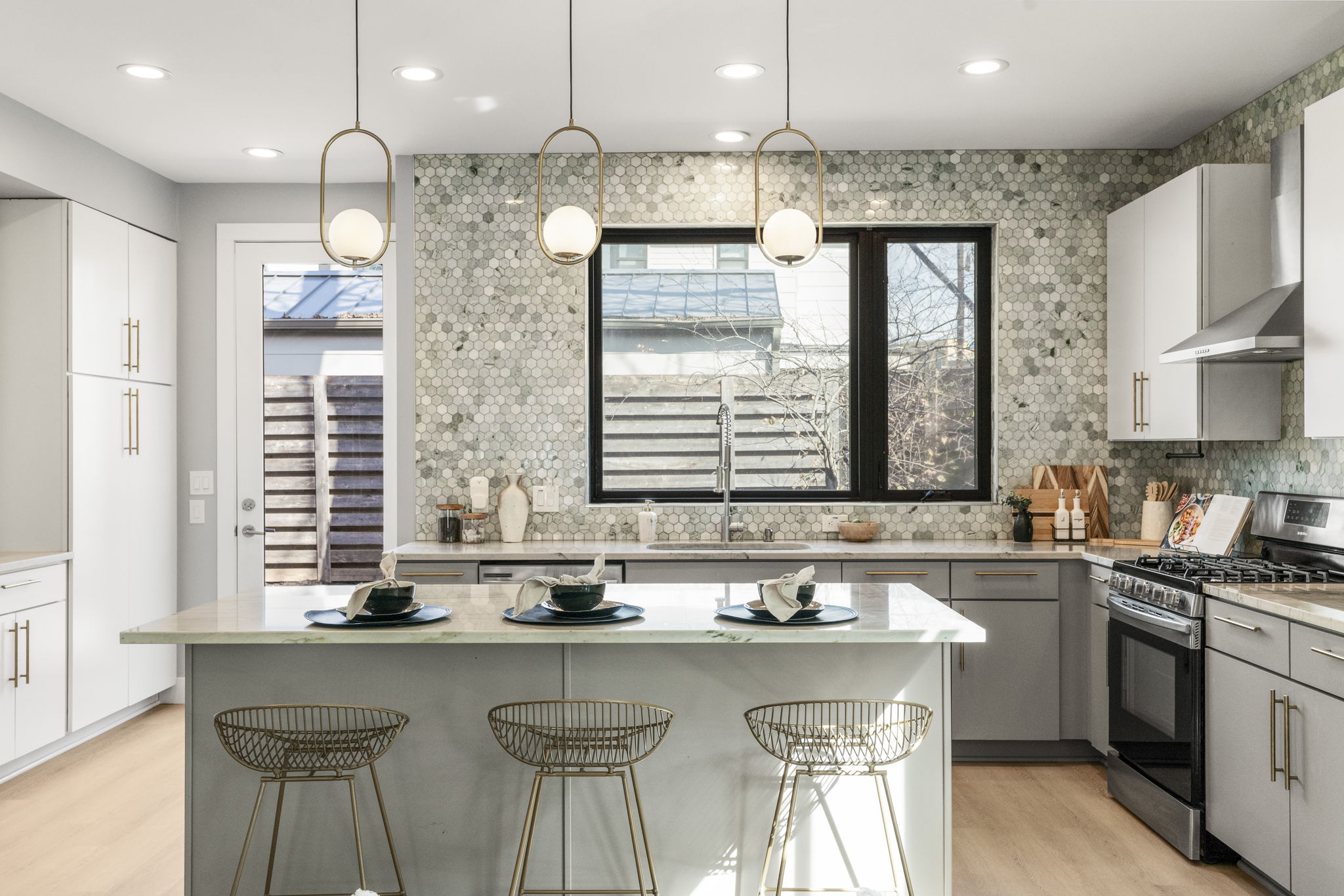 3612 Thompson Street, Unit 1 Austin, TX 78702 - Photo 2 of 40 A chef-forward kitchen anchors the main level with a large island, sleek cabinetry, and statement lighting.