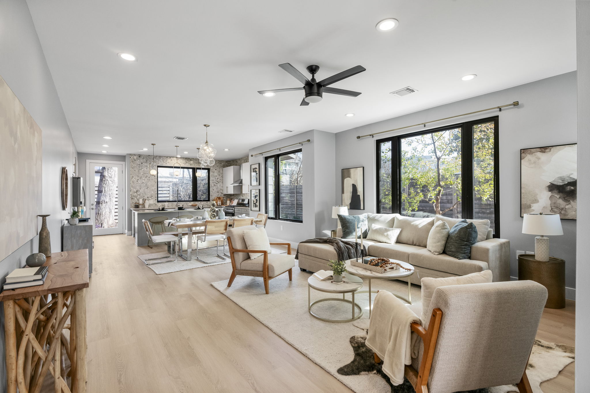3612 Thompson Street, Unit 1 Austin, TX 78702 - Photo 8 of 40 The open living area is airy and grounded, with wide-plank floors and oversized windows framing the backyard.