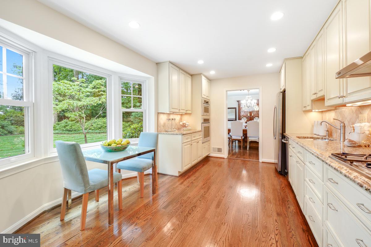 11321 Marcliff Road North Bethesda, MD 20852 - Photo 12 of 48 a kitchen with a table chairs refrigerator and window