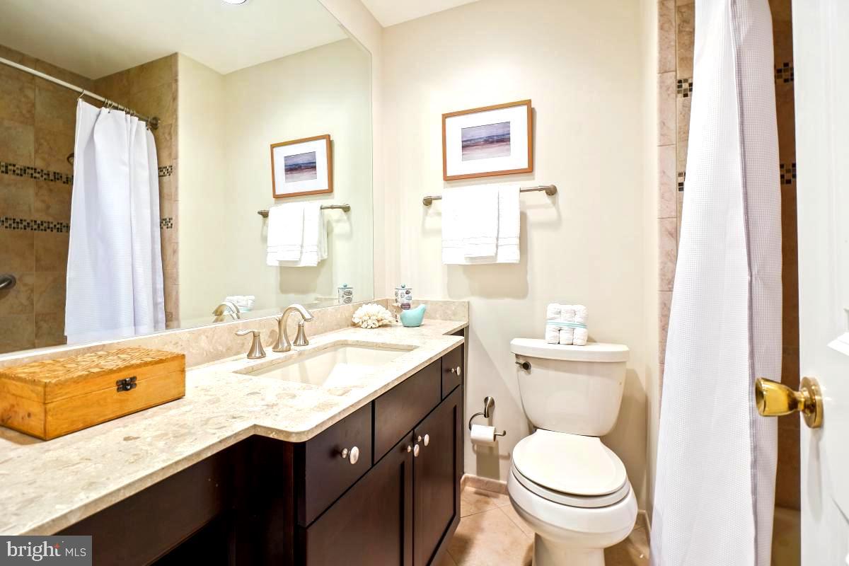 11321 Marcliff Road North Bethesda, MD 20852 - Photo 24 of 48 a bathroom with a granite countertop toilet sink and a mirror