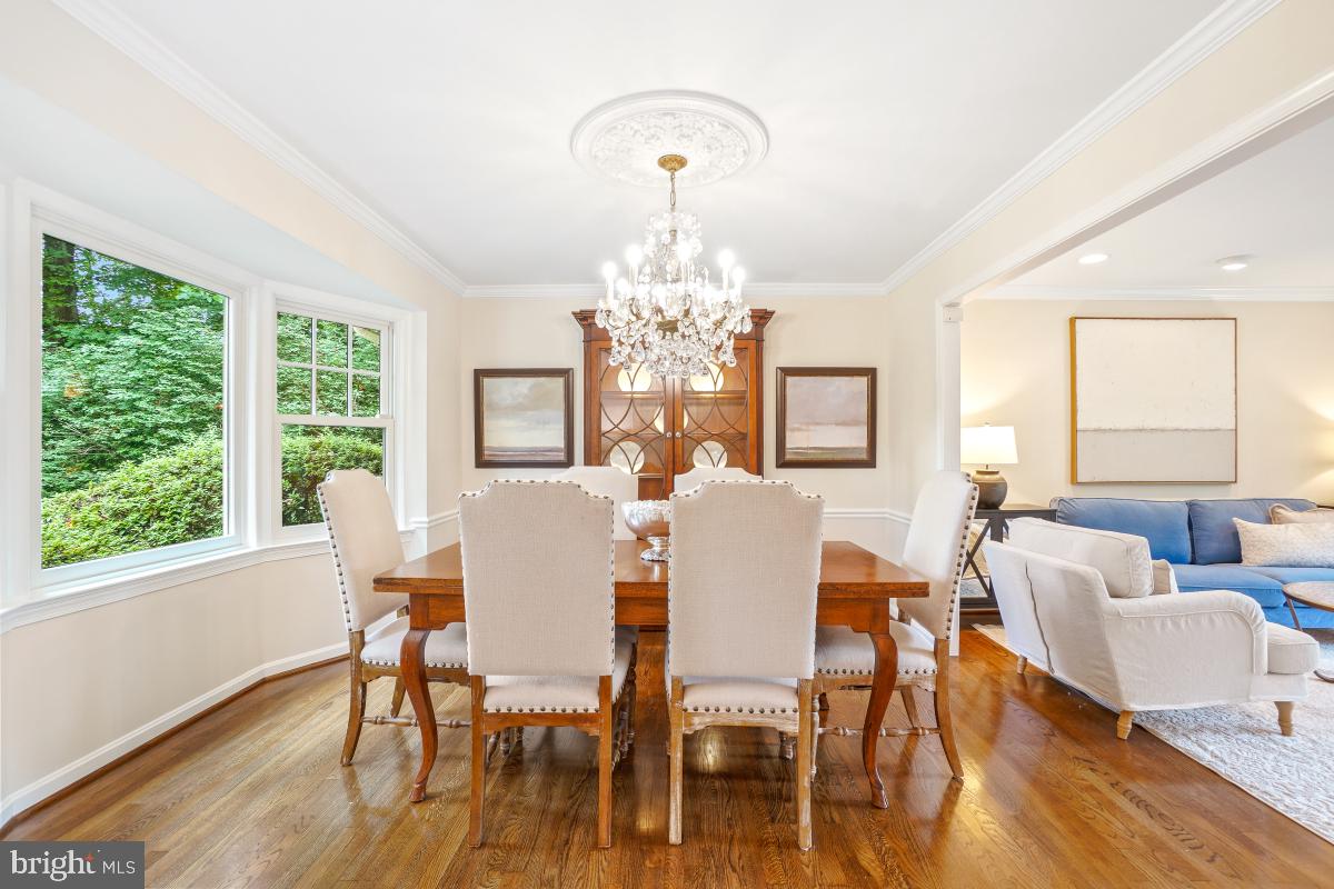 11321 Marcliff Road North Bethesda, MD 20852 - Photo 9 of 48 a dining room with wooden floor a chandelier a glass table and chairs