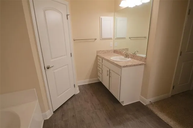 a bathroom with a sink a mirror and shower
