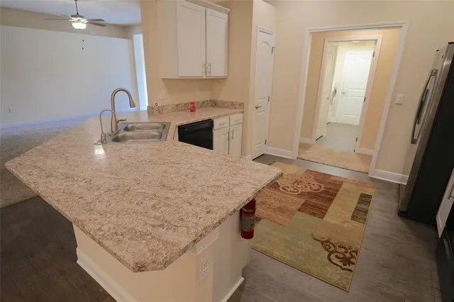 a kitchen with a sink a stove and cabinets
