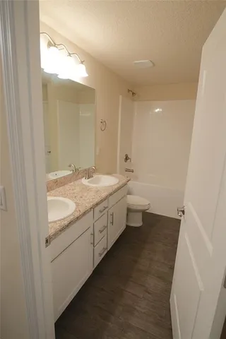 a bathroom with a double vanity sink and mirror