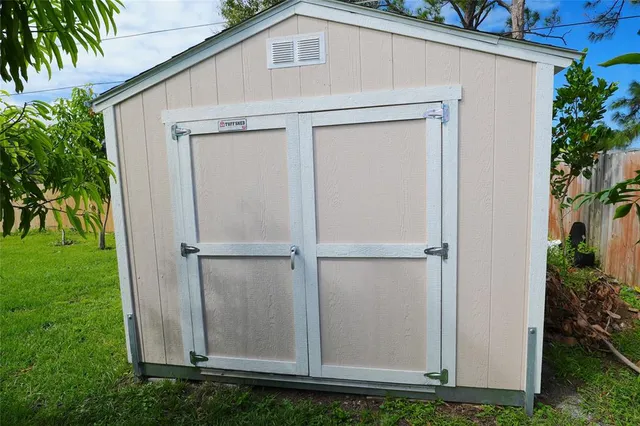 a view of a small house with backyard