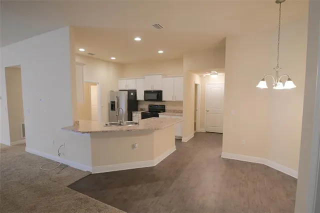 a view of kitchen with center island and stainless steel appliances