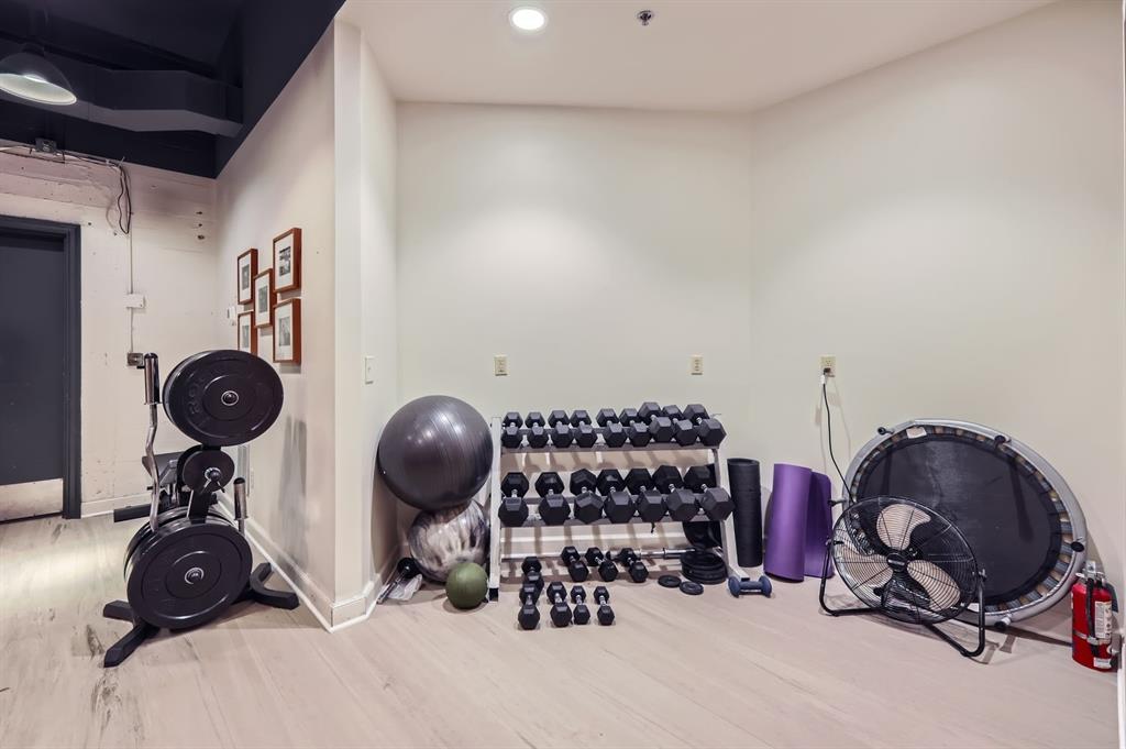 710 Colorado Street, Unit 4J Austin, TX 78701 - Photo 31 of 37 Workout room featuring recessed lighting, baseboards, and wood finished floors