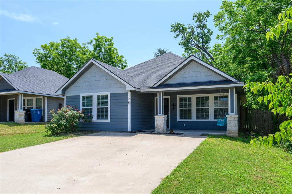 318 Munson Street Denison, TX 75021 - Photo 3 of 21 a house with garden in front of it