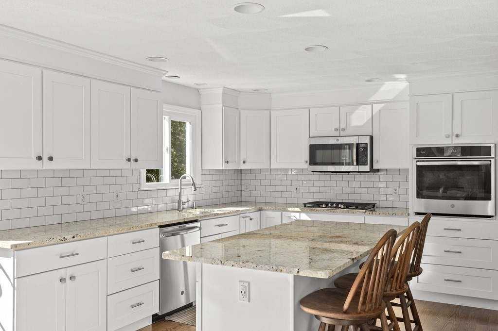 35 Chapelgate Road Canton, MA 02021 - Photo 3 of 41 a kitchen with granite countertop a sink stainless steel appliances and white cabinets