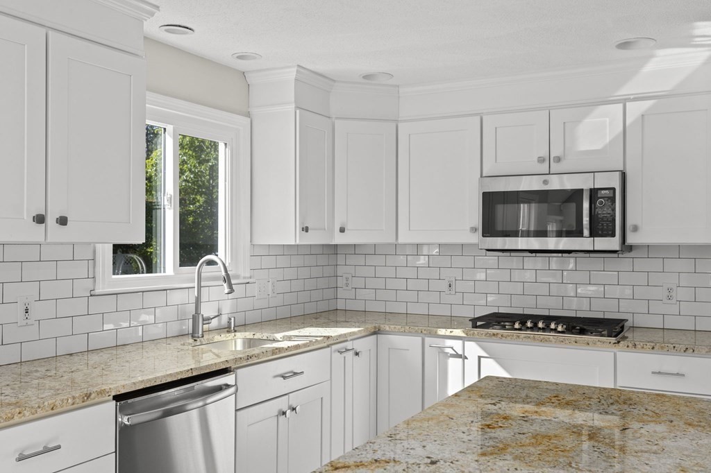35 Chapelgate Road Canton, MA 02021 - Photo 4 of 41 a kitchen with granite countertop white cabinets sink and stainless steel appliances