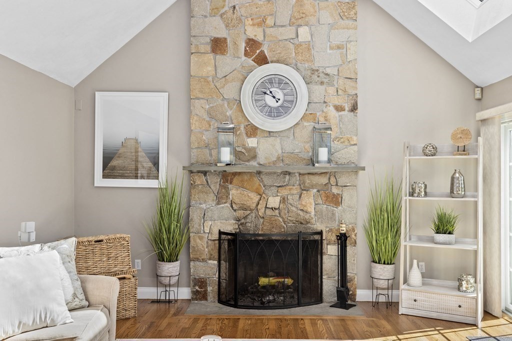 35 Chapelgate Road Canton, MA 02021 - Photo 10 of 41 a living room with a fireplace and a clock