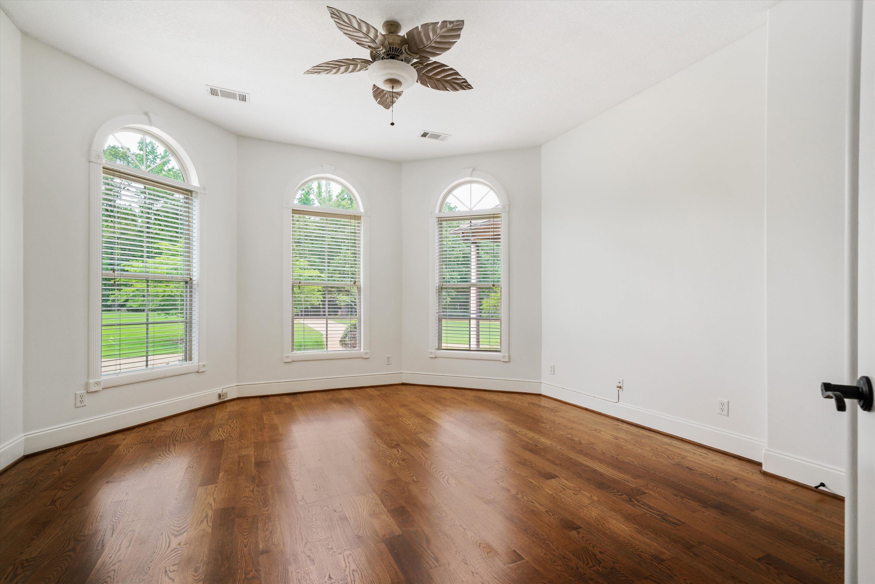 10335 Monroe Road Lakeland, TN 38002 - Photo 22 of 30 Empty room featuring ceiling fan, a healthy amount of sunlight, and wood-type flooring