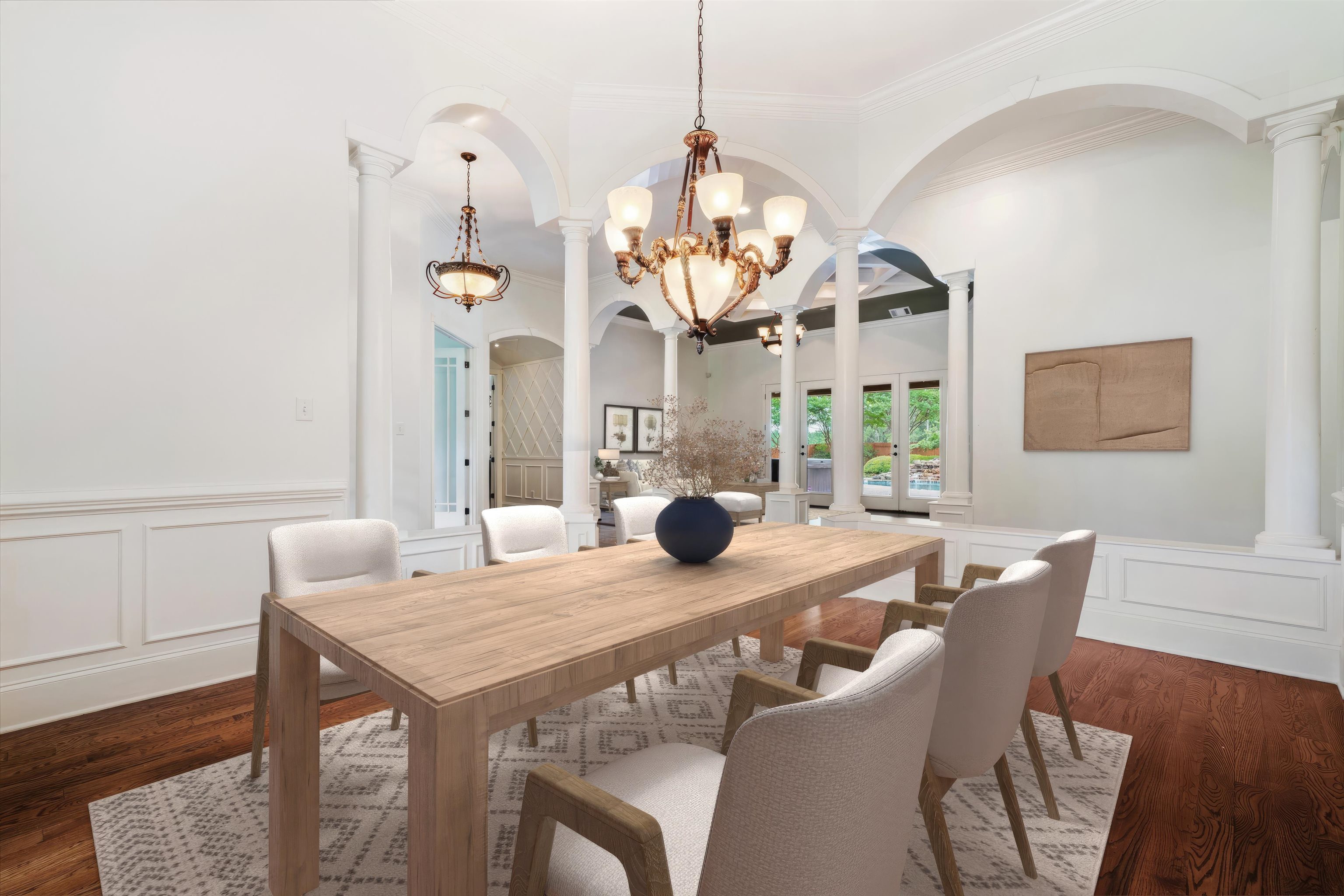 10335 Monroe Road Lakeland, TN 38002 - Photo 5 of 30 Dining room featuring decorative columns, ornamental molding, an inviting chandelier, and dark wood-type flooring