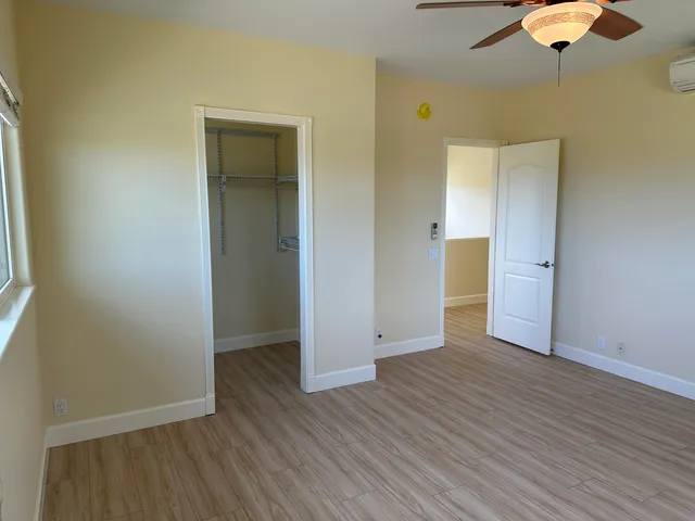 an empty room with wooden floor and closet