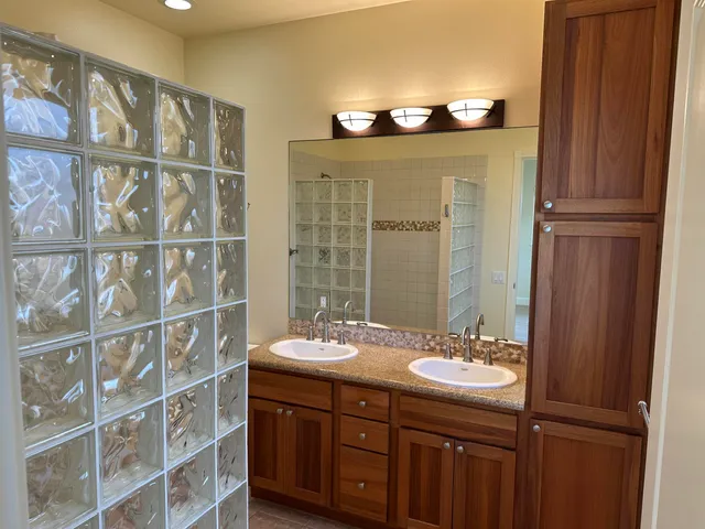 a bathroom with a double vanity sink and a mirror