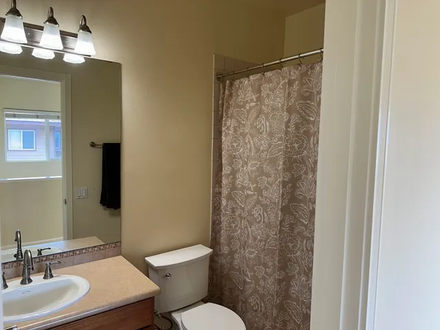 a bathroom with a toilet a sink and a mirror