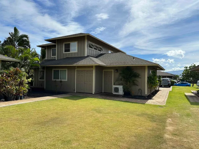 a view of a house with swimming pool and a yard