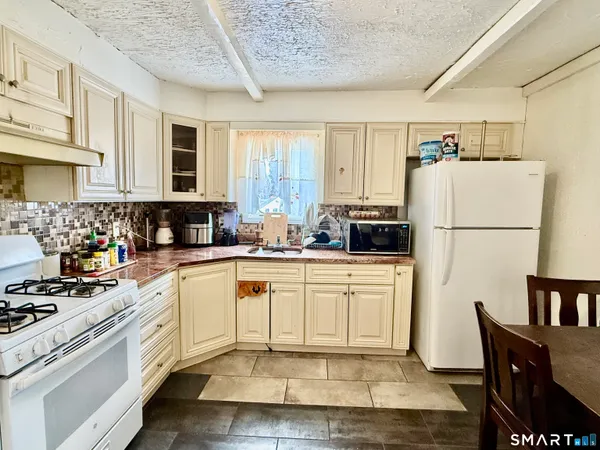 a kitchen with refrigerator cabinets and wooden floor