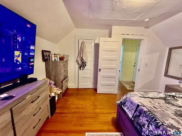 a bedroom with a bed and a desk