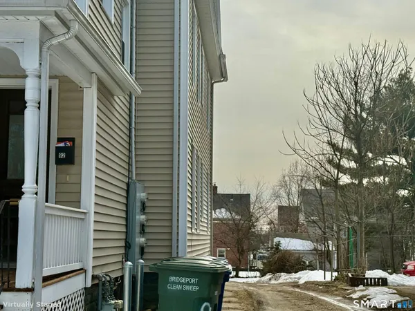 a view of a big house with a big yard and large trees