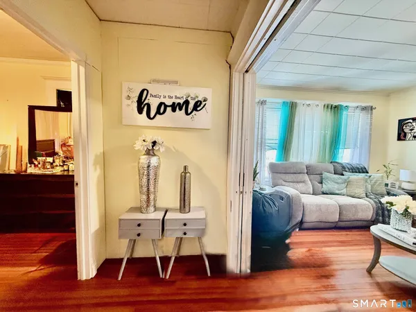 a living room with furniture and wooden floor
