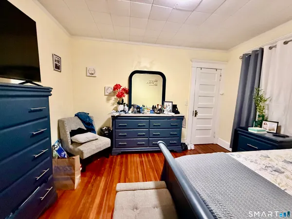 a bedroom with a bed and a flat screen tv