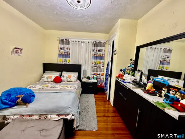 a bedroom with furniture and a flat screen tv