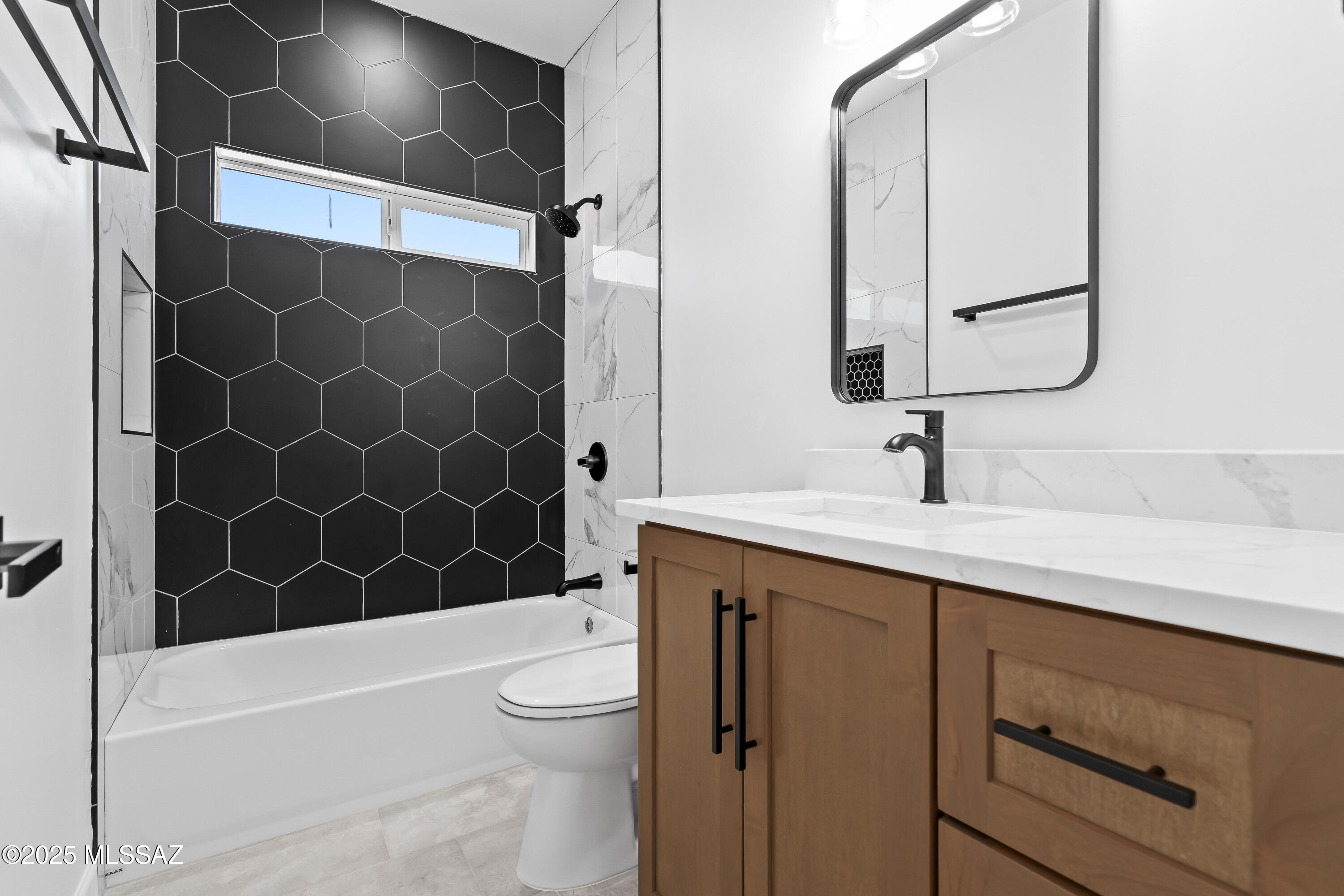 1667 Ave Calamar Rio Rico, AZ 85648 - Photo 25 of 33 a bathroom with a sink a toilet and a bathtub