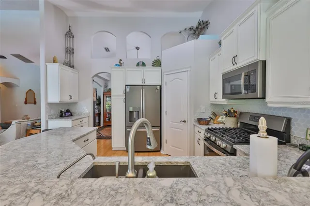 a view of a dining room with furniture a chandelier and wooden floor