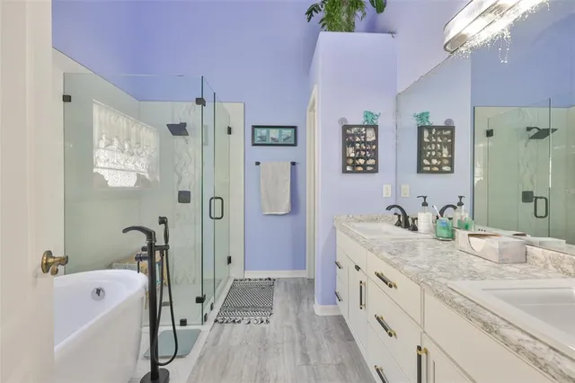 a bedroom with a large bed and a tv on the dresser