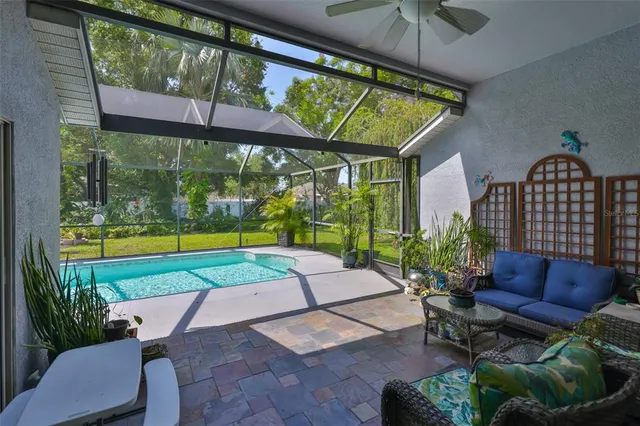 a view of swimming pool with seating space