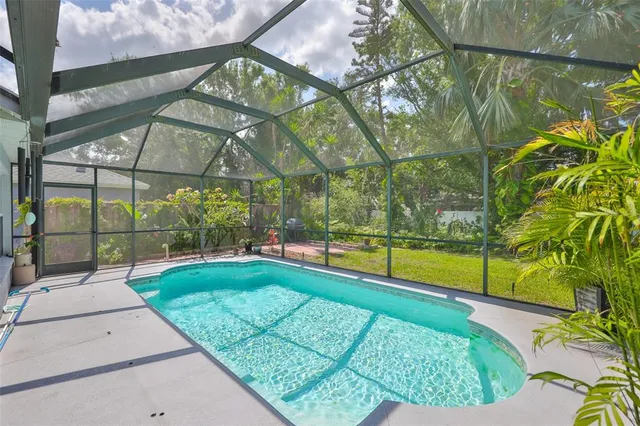 a backyard of a house with yard and trampoline