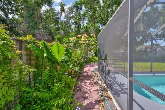 an aerial view of a house with a swimming pool outdoor seating and yard