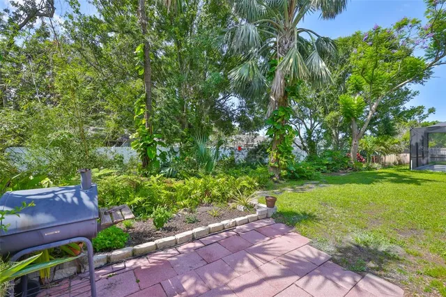 an aerial view of a house with a garden and lake view