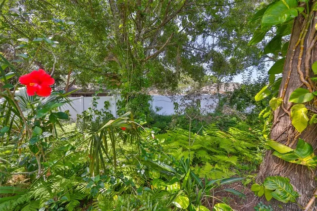 an aerial view of residential houses with outdoor space and lake view