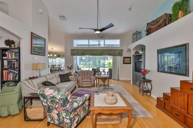a living room with furniture a flat screen tv and a large window