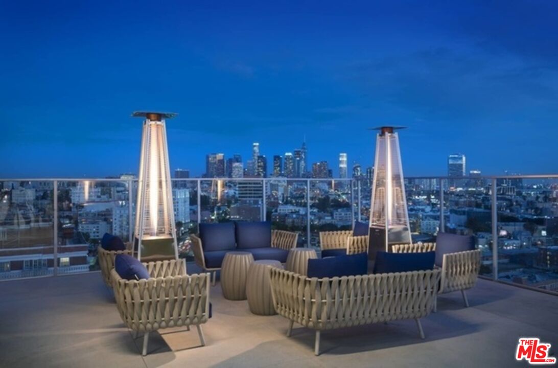 3033 Wilshire Boulevard, Unit 1113 Los Angeles, CA 90020 - Photo 20 of 31 a view of a balcony with chair and tables